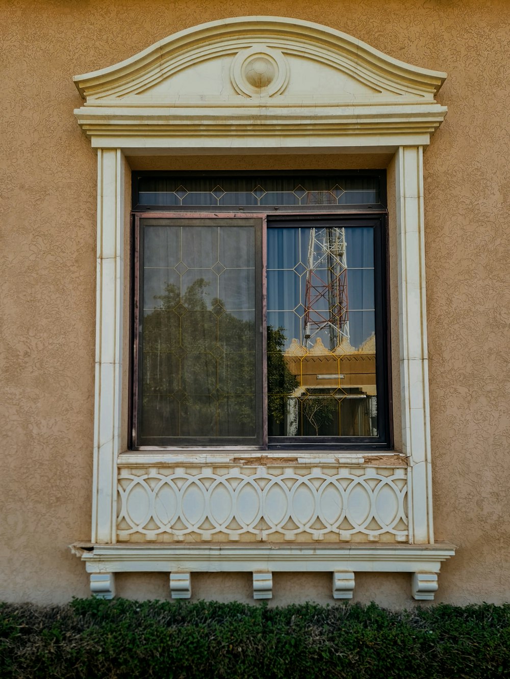 a window with a reflection of a building in it