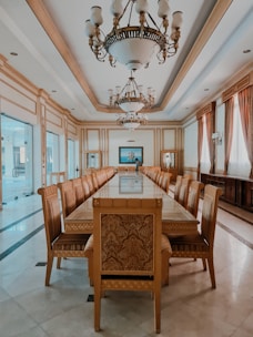 Elegant dining room with wooden table and chandelier.