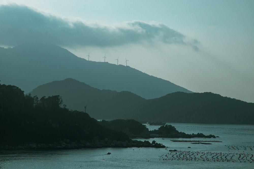 a body of water with a mountain in the background