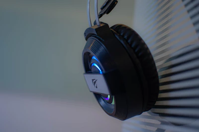 Close-up of stylish headphones resting on a sleek black surface.