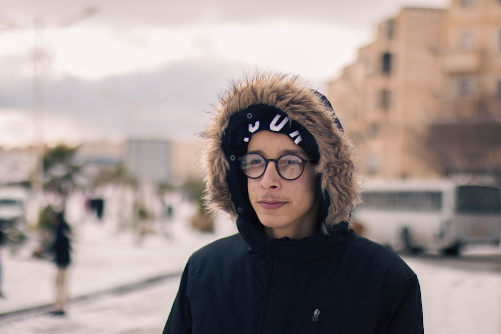 a man wearing a furry hat and glasses