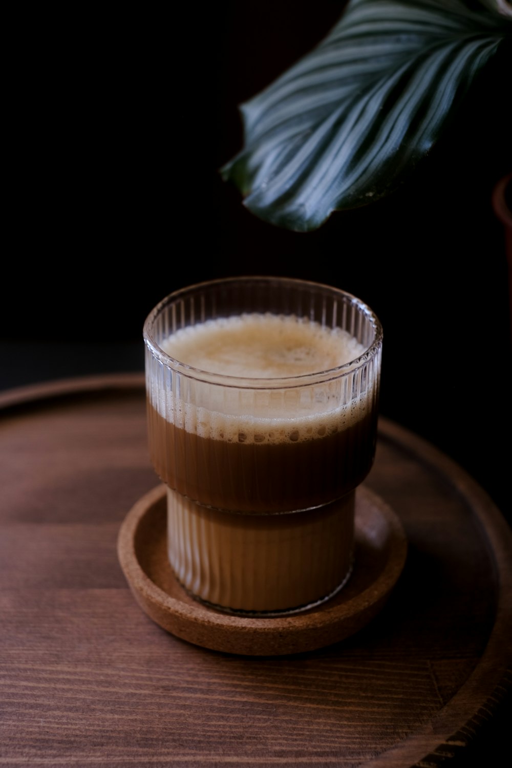 a cup of coffee sitting on top of a wooden tray