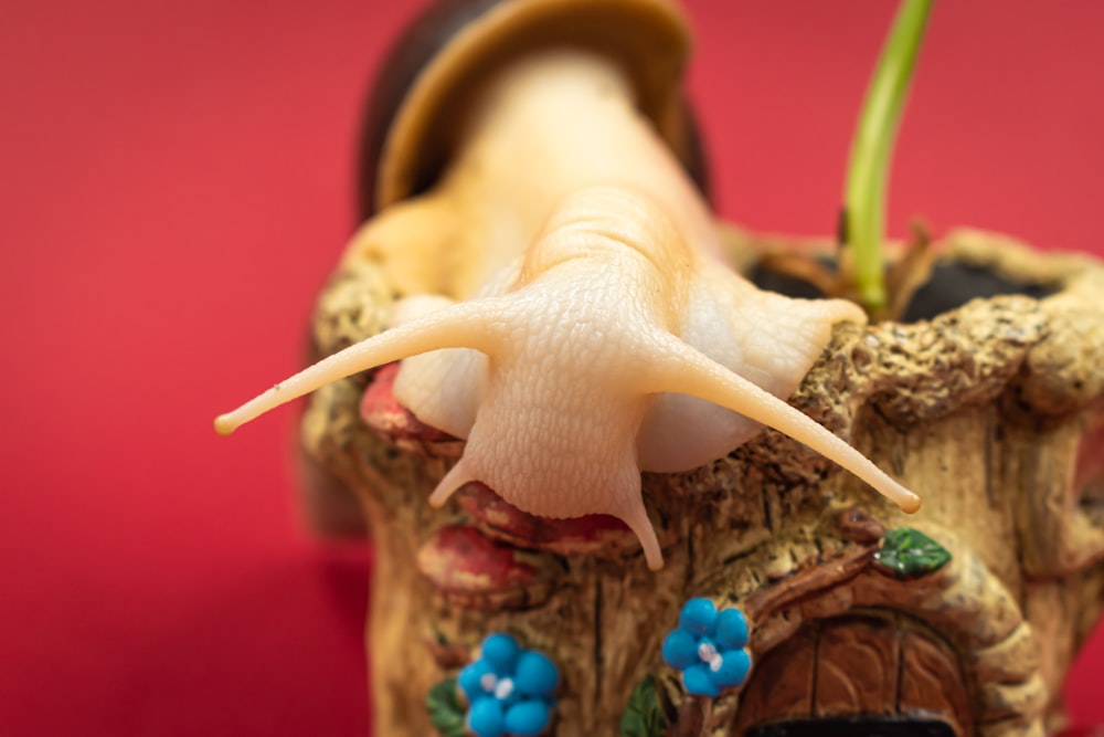 a close up of a small figurine of a snail