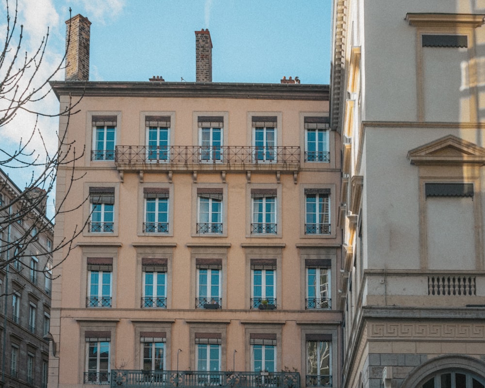 a building with balconies and a clock on the front of it