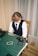 a young boy sitting at a green table with cards