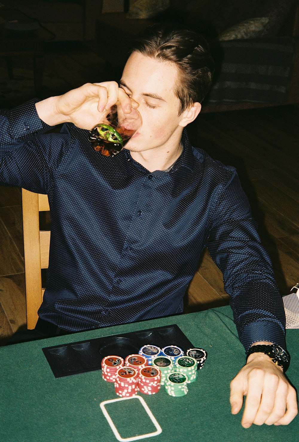 a man sitting at a table eating a sandwich