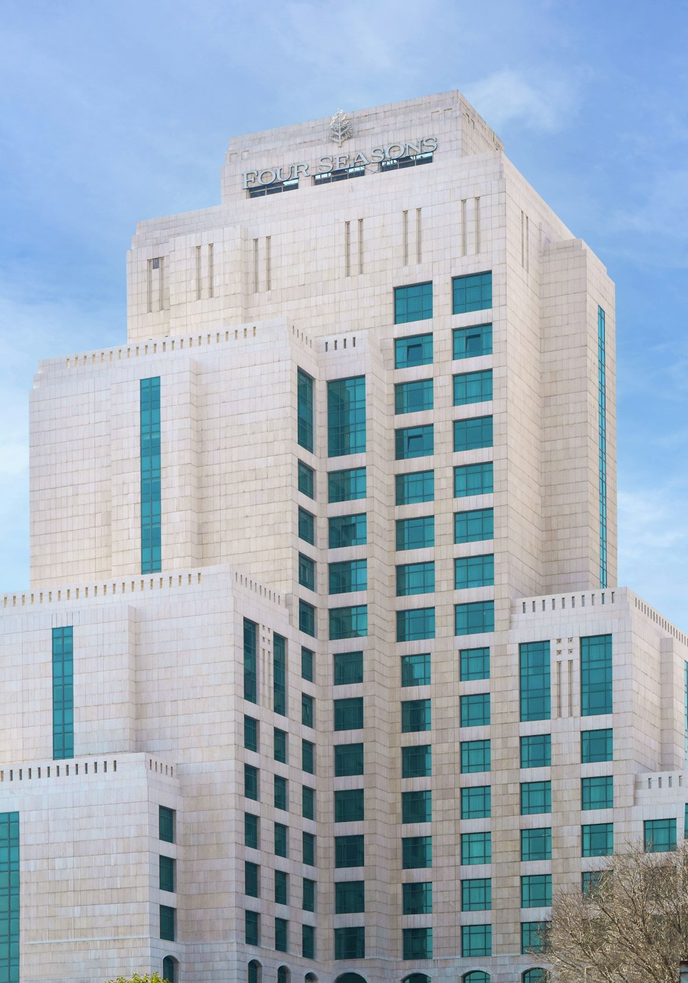 a large white building with a clock on the top of it