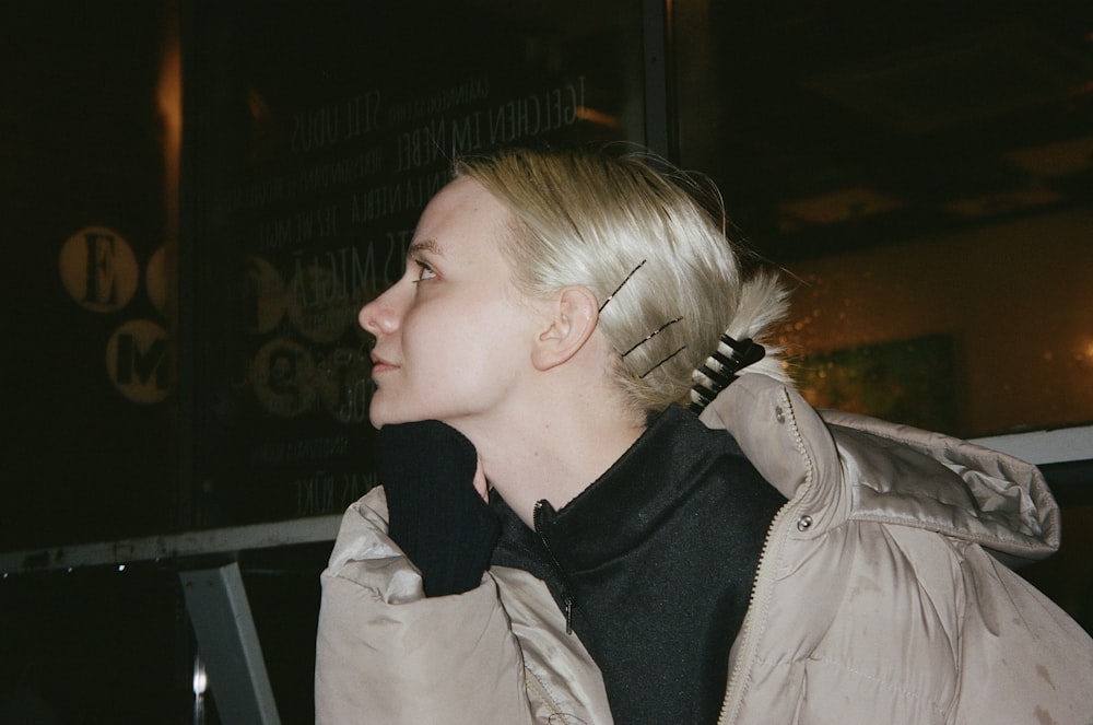 a woman with blond hair wearing a black scarf
