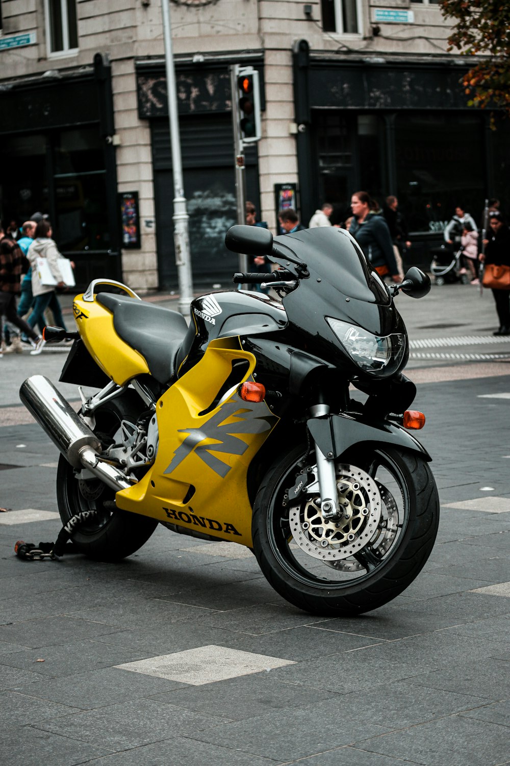 a yellow and black motorcycle parked on the side of the road