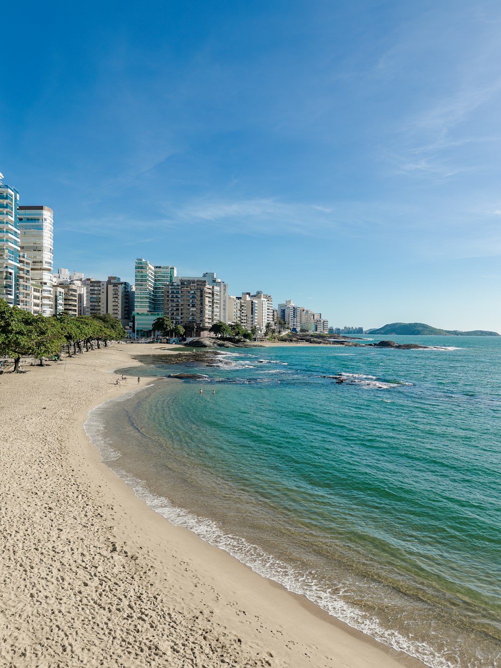 Ein Strand mit einer Stadt im Hintergrund