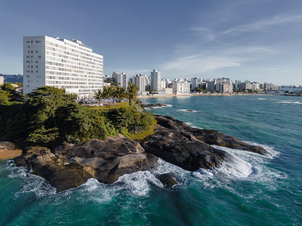 an aerial view of a beach with a hotel in the background