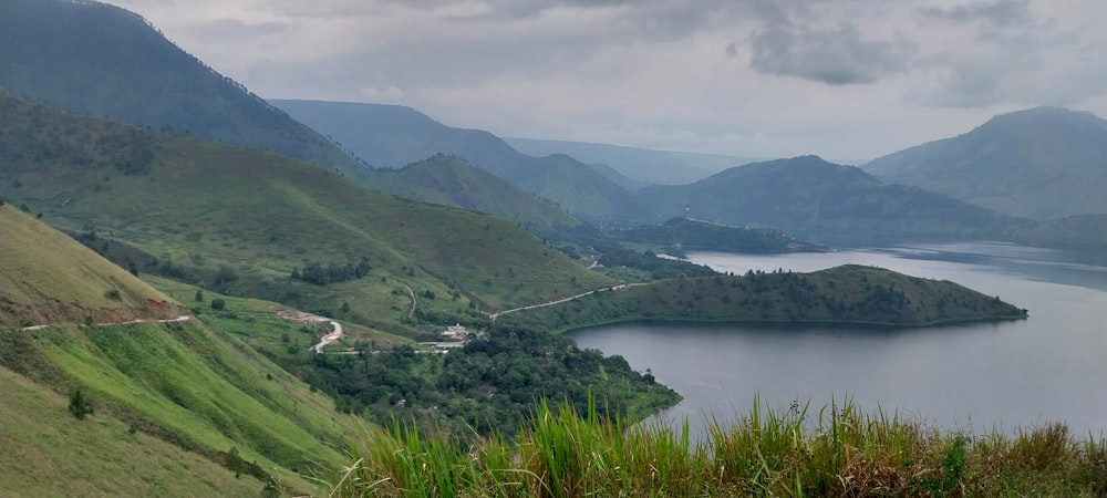 a scenic view of a body of water surrounded by mountains