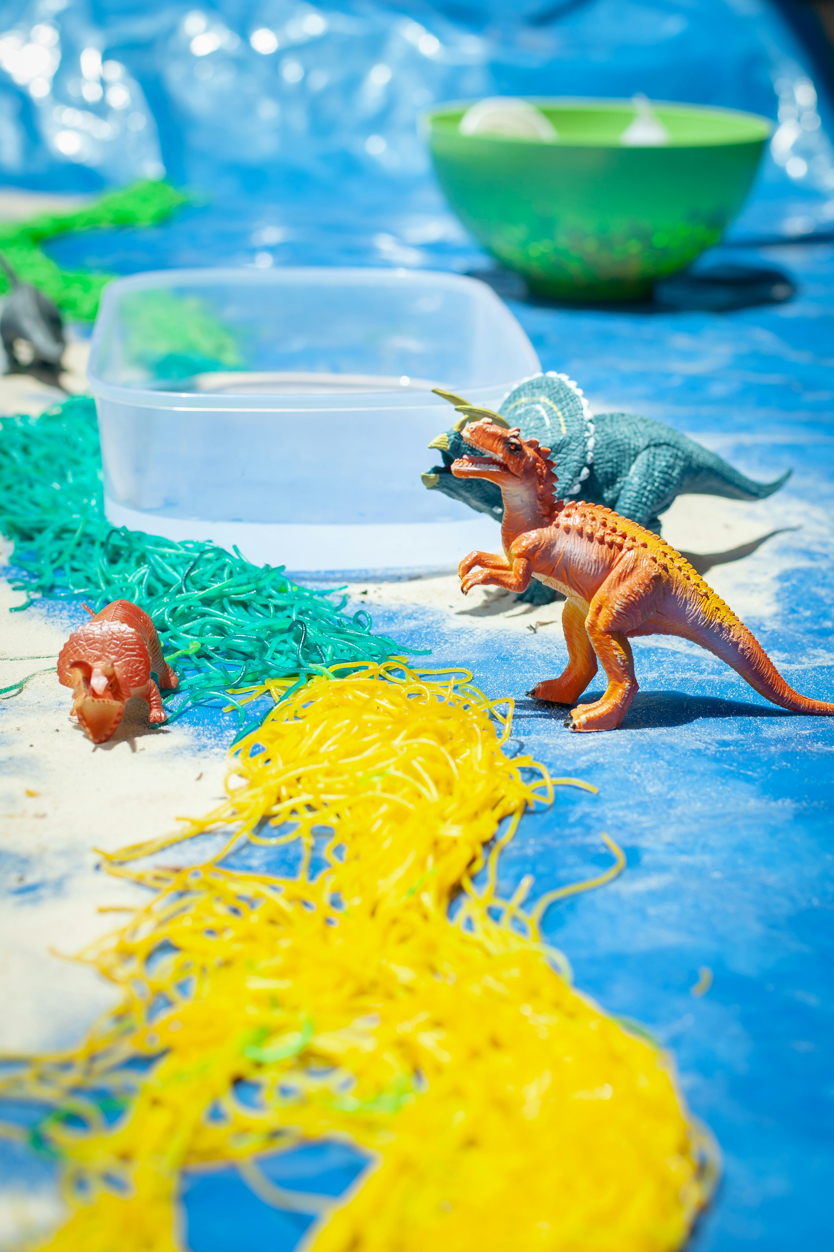 a plastic toy dinosaur and a plastic toy dinosaur on a table