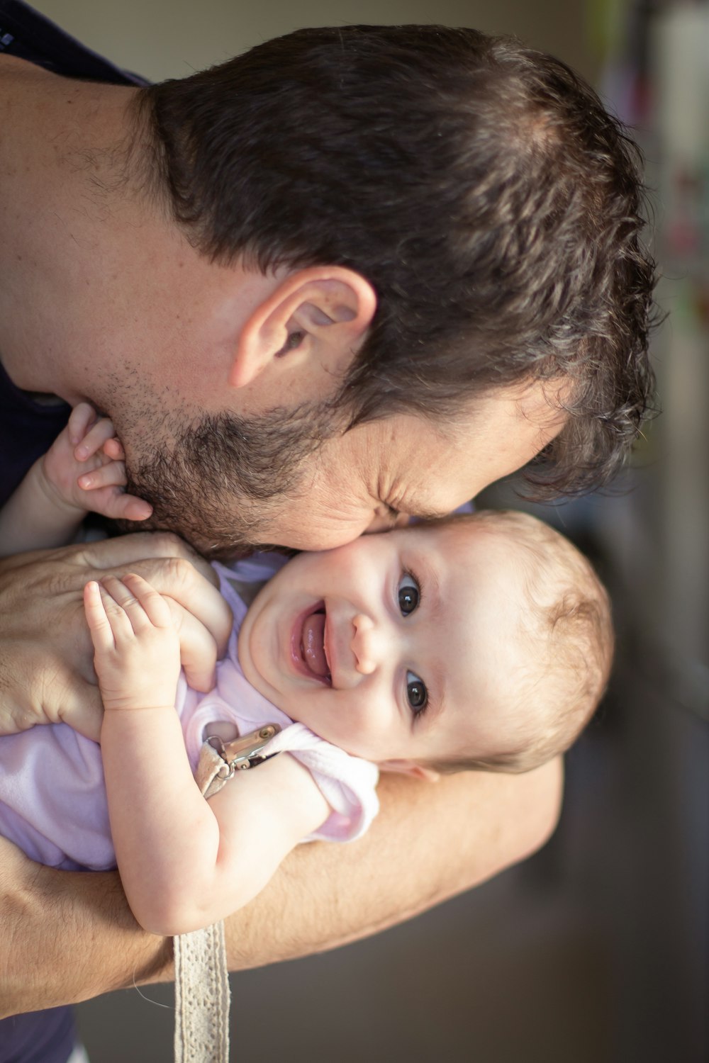 a man holding a baby in his arms