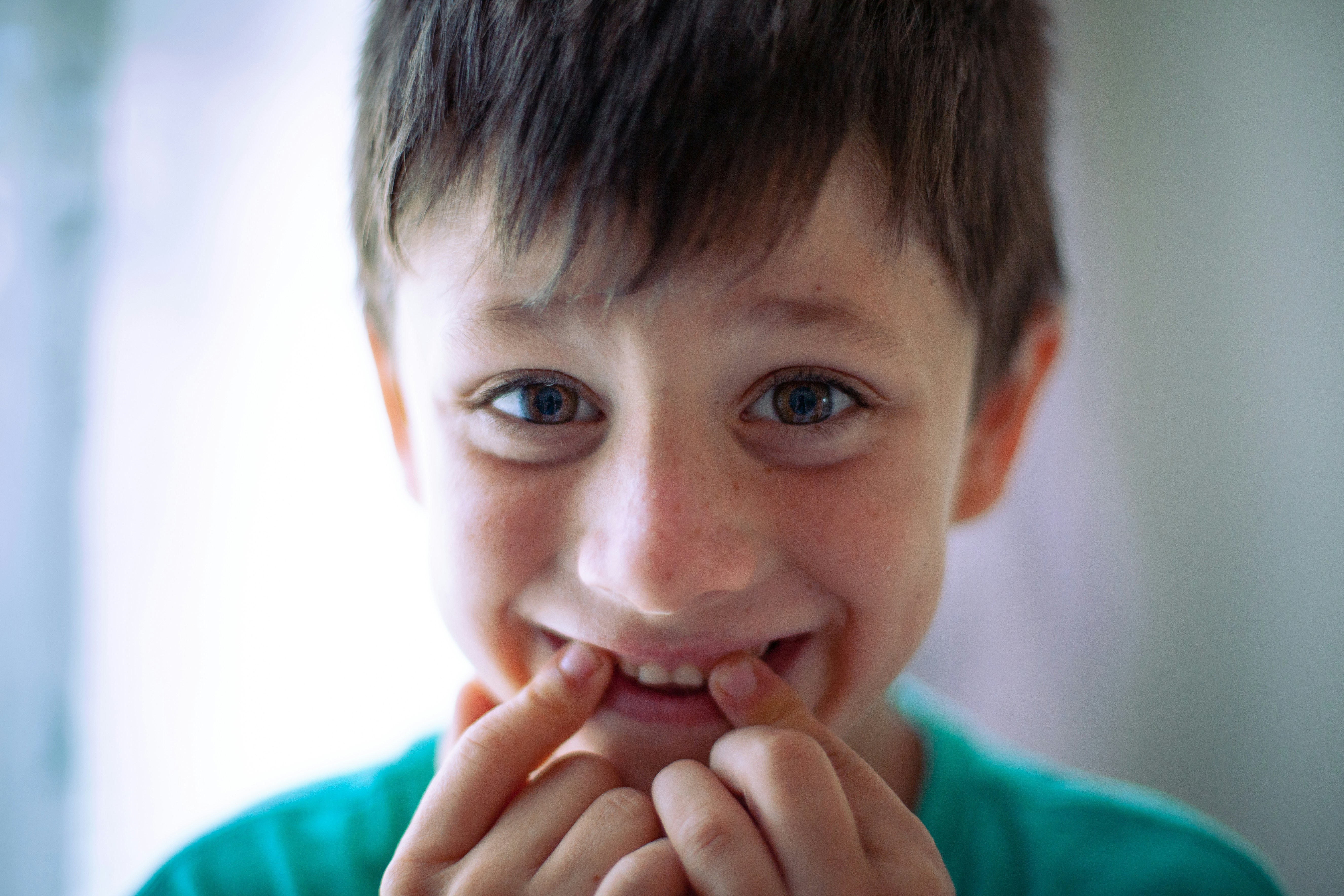 a young boy with a toothbrush in his mouth