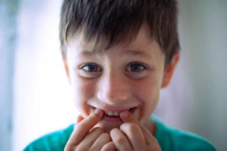 a young boy with a toothbrush in his mouth