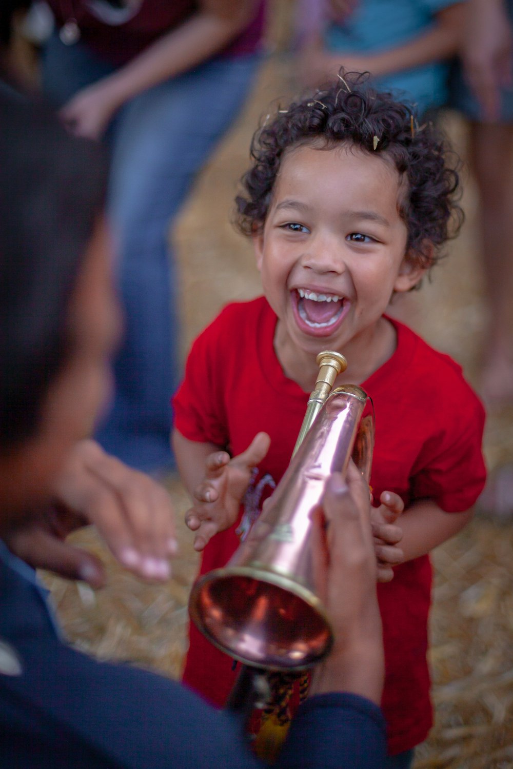 a little boy is holding a champagne bottle and laughing