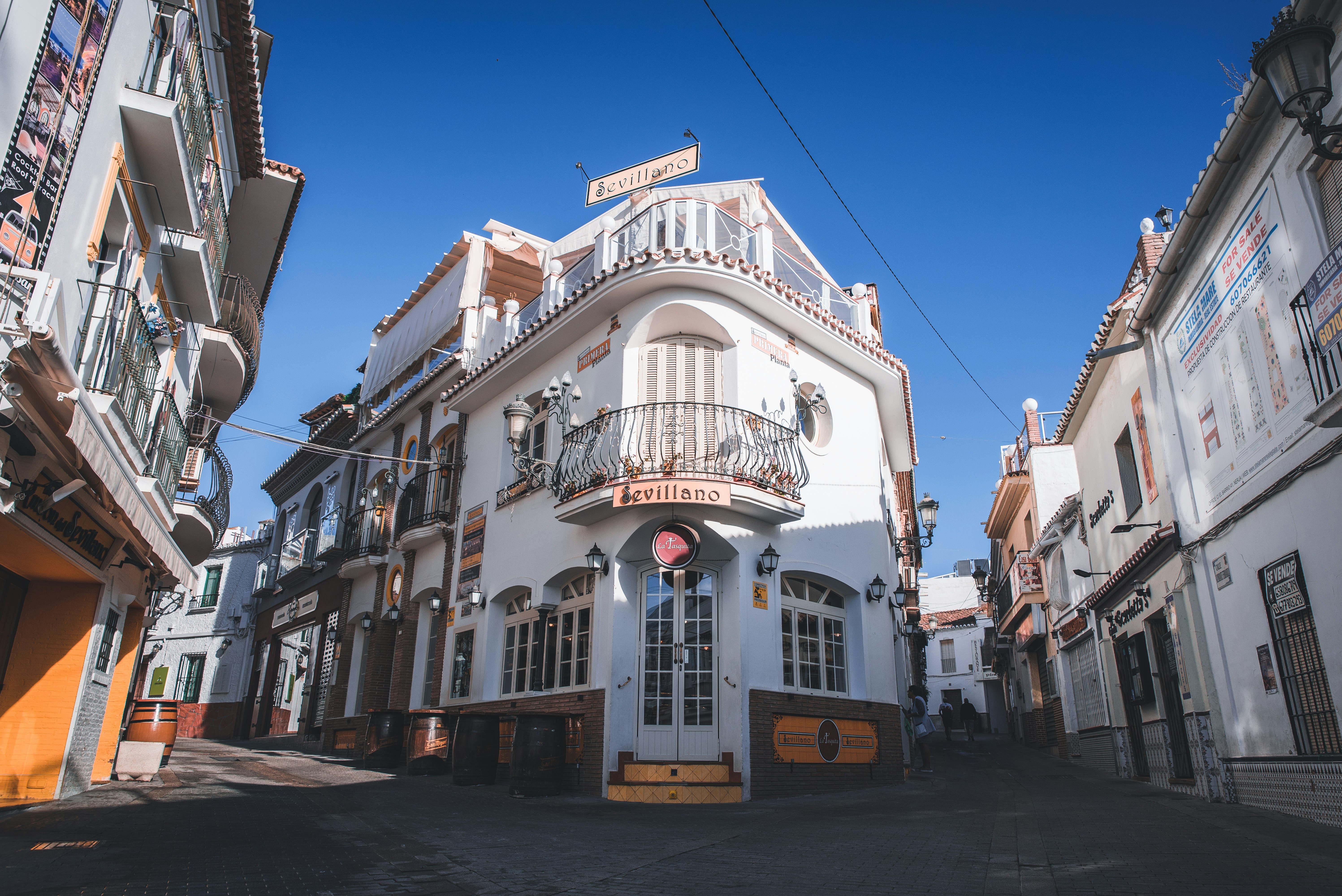 a white building with a balcony and balconies
