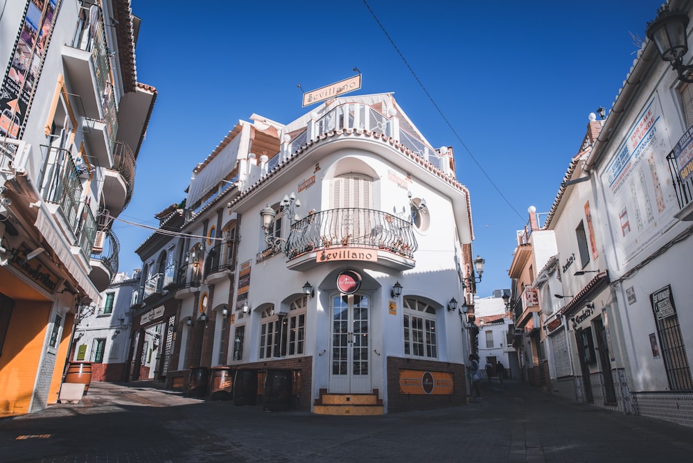 a white building with a balcony and balconies