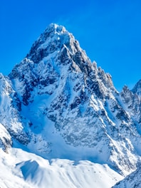 a mountain covered in snow under a blue sky
