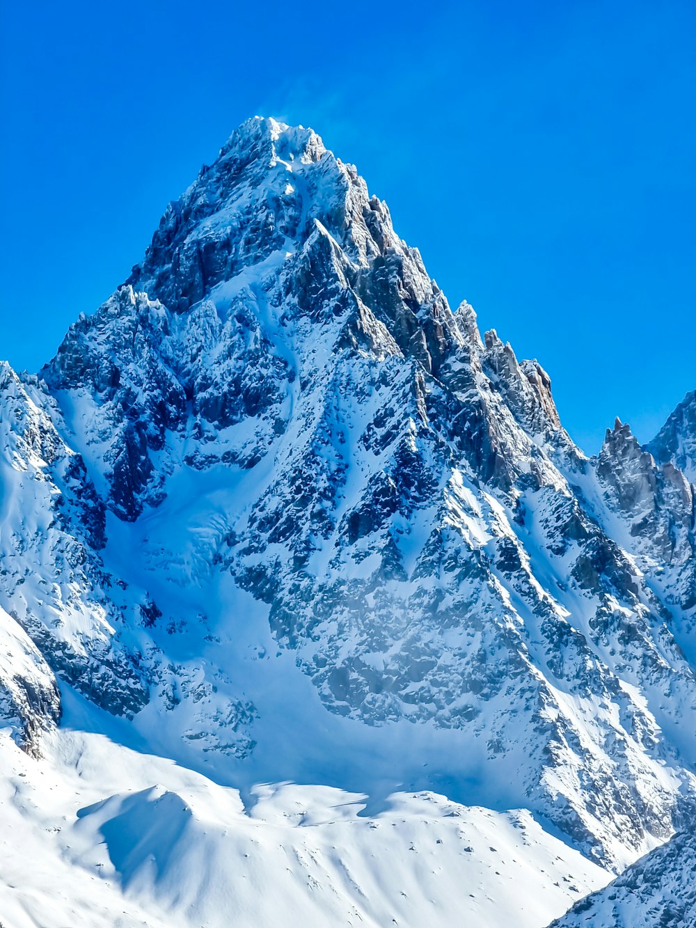 a mountain covered in snow under a blue sky