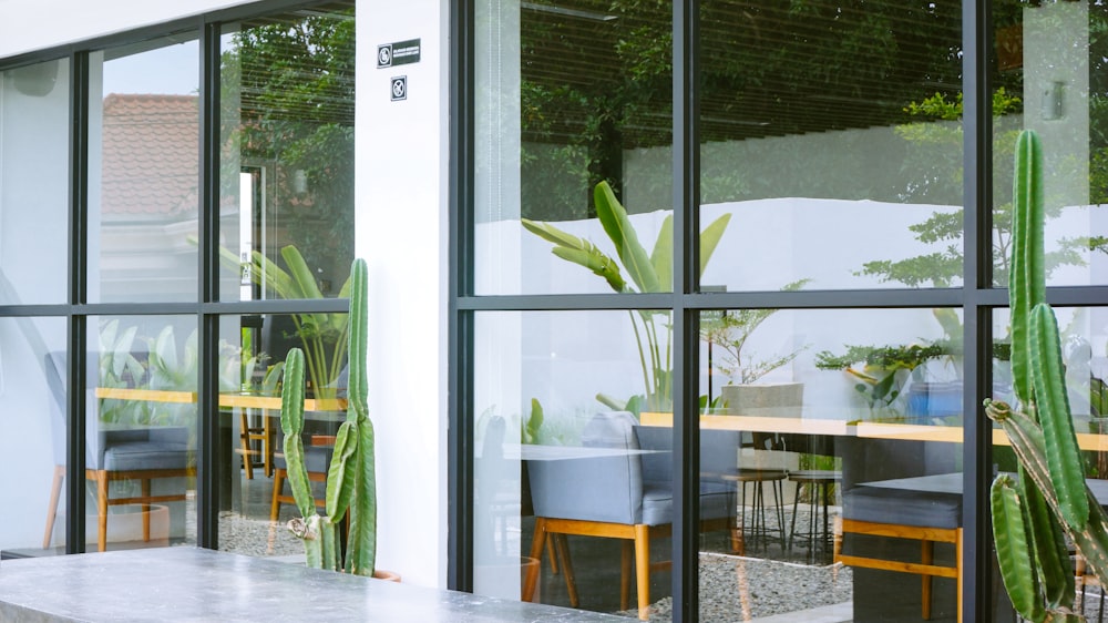 a table and chairs in front of a large window