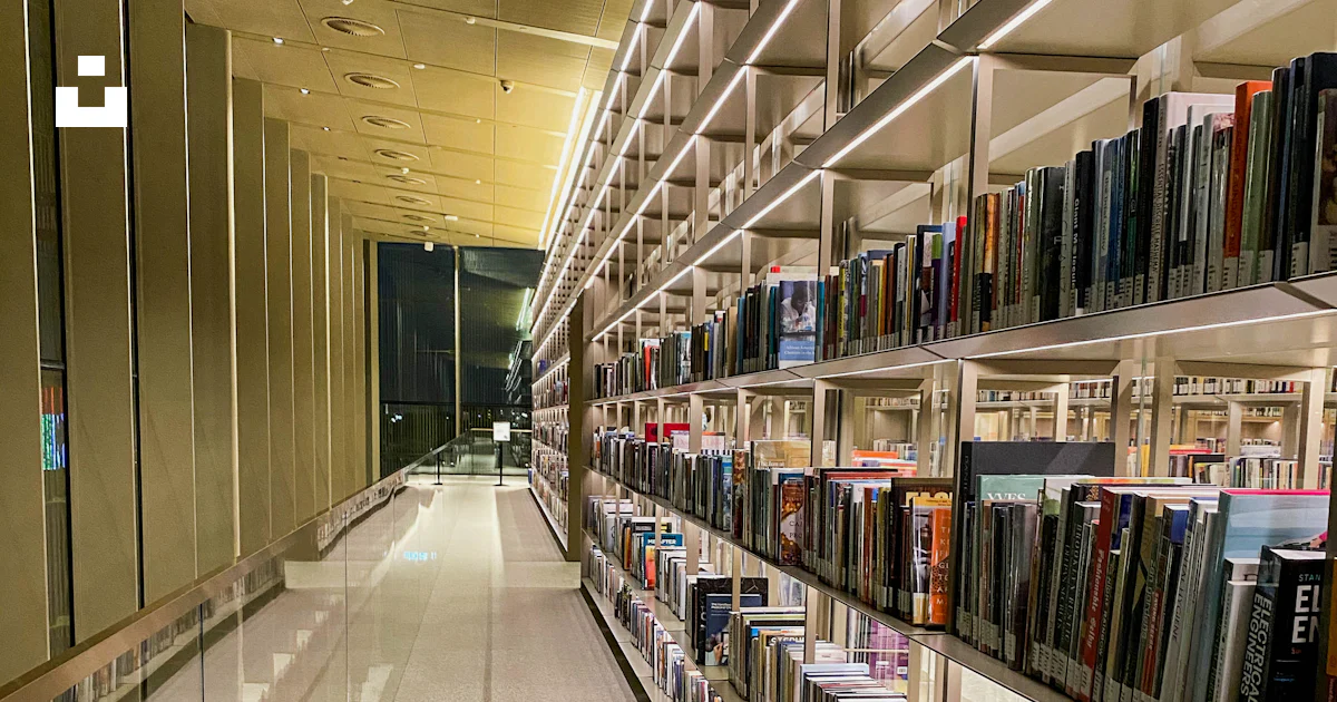 A row of books on shelves in a library photo – Free Building Image on ...