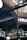 An intricate metal framework supports a large industrial ceiling. The structure includes various beams and ornate designs with light filtering through slotted windows. The scene is reminiscent of an old factory or market hall with its heavy reliance on metal construction.