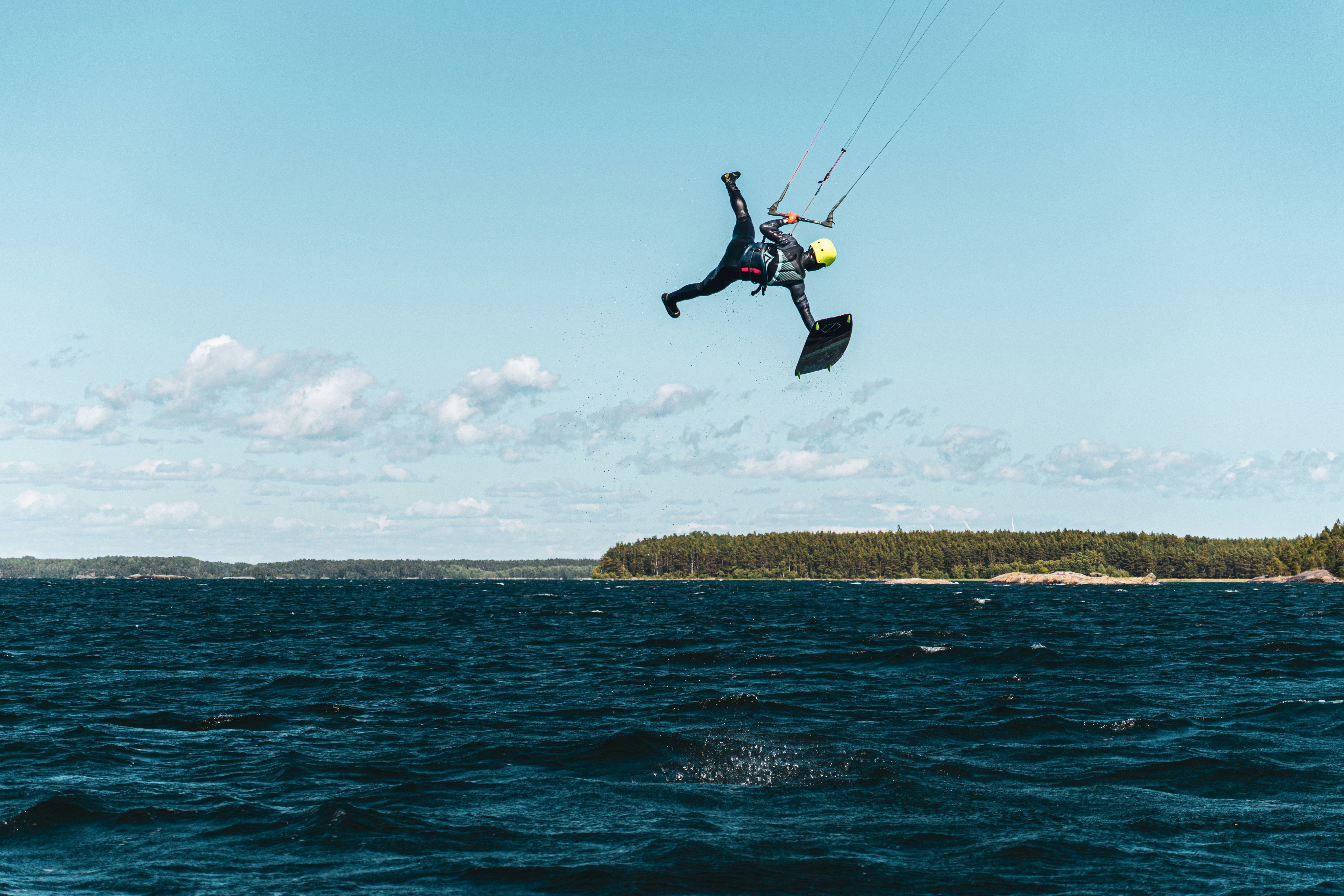 a person on a surfboard in the air above the water