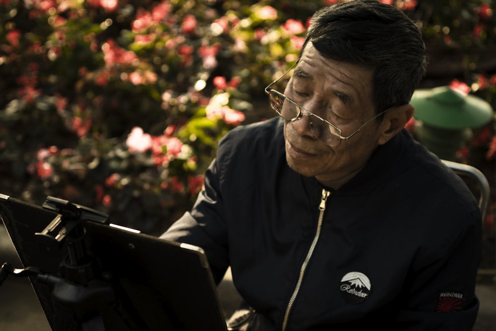 a man sitting in front of a laptop computer