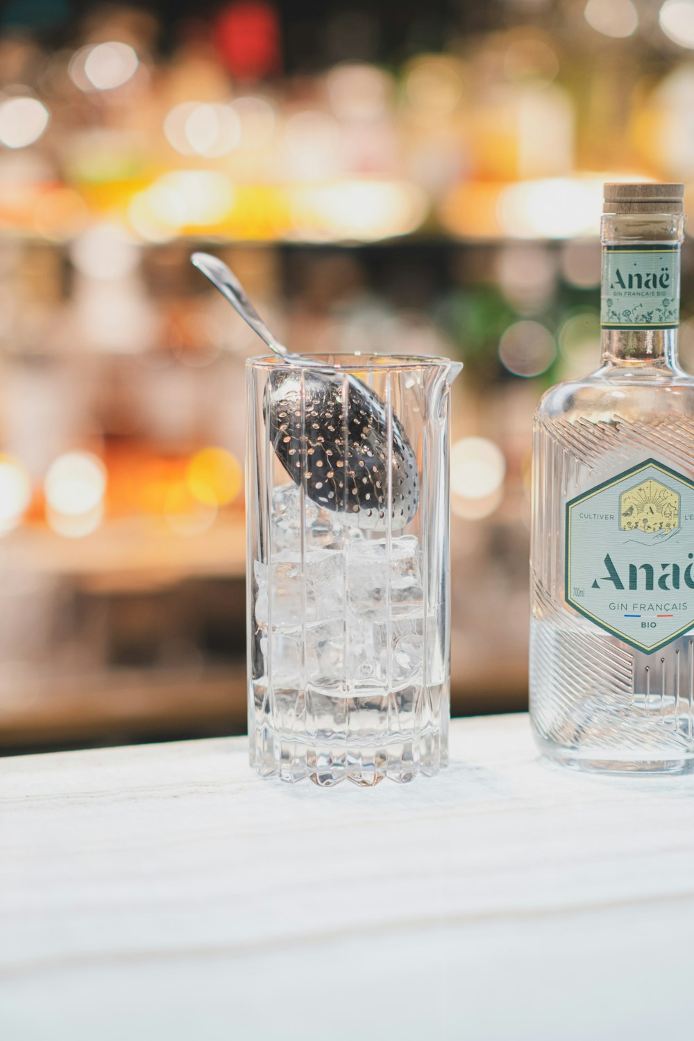 a bottle and a glass sitting on a table