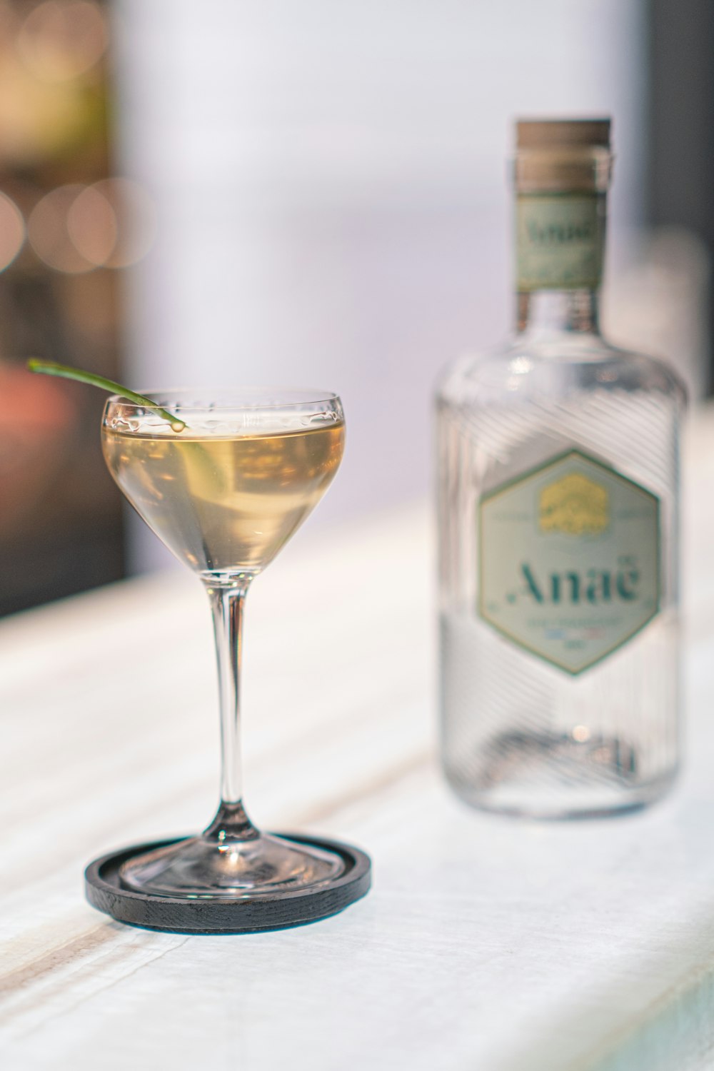 a bottle of alcohol and a glass on a table