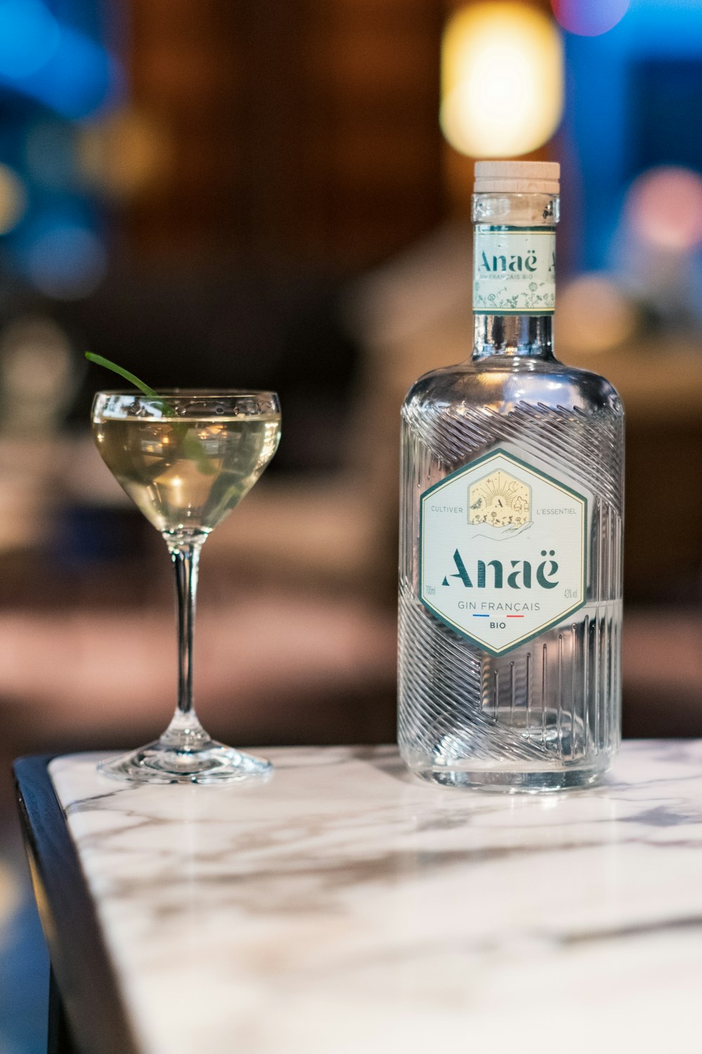 a bottle of alcohol and a glass on a table