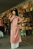 A smiling customer holding a unique thrifted handbag in the ethrift store.