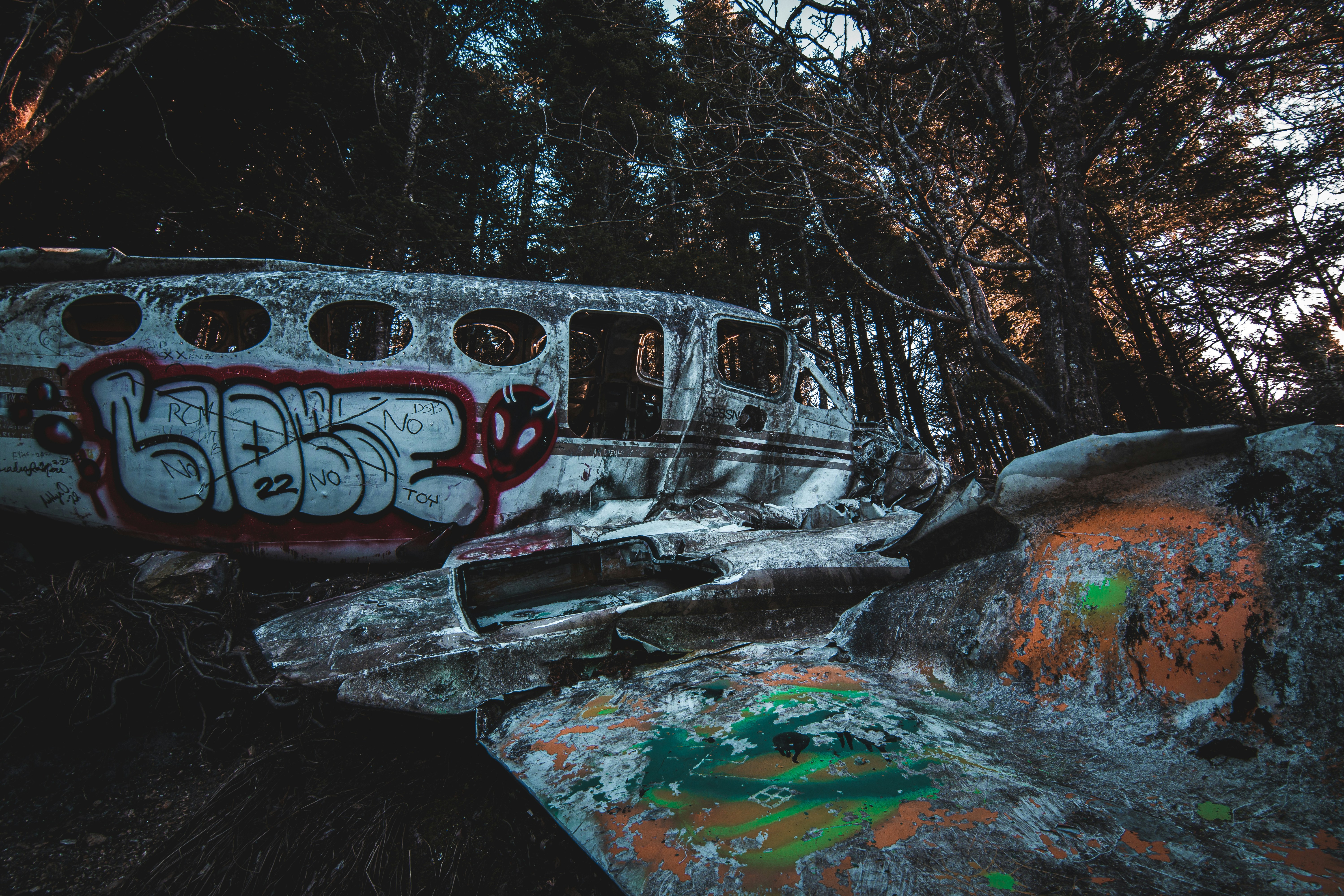 a run down train car with graffiti on it, the wing to the body left behind