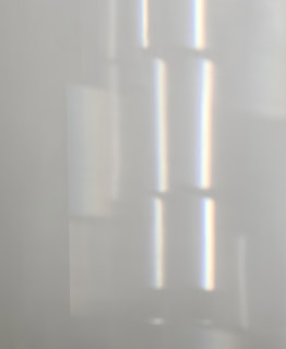 Close-up of delicate horizontal lines in soft gray tones, resembling the gentle flow of time.