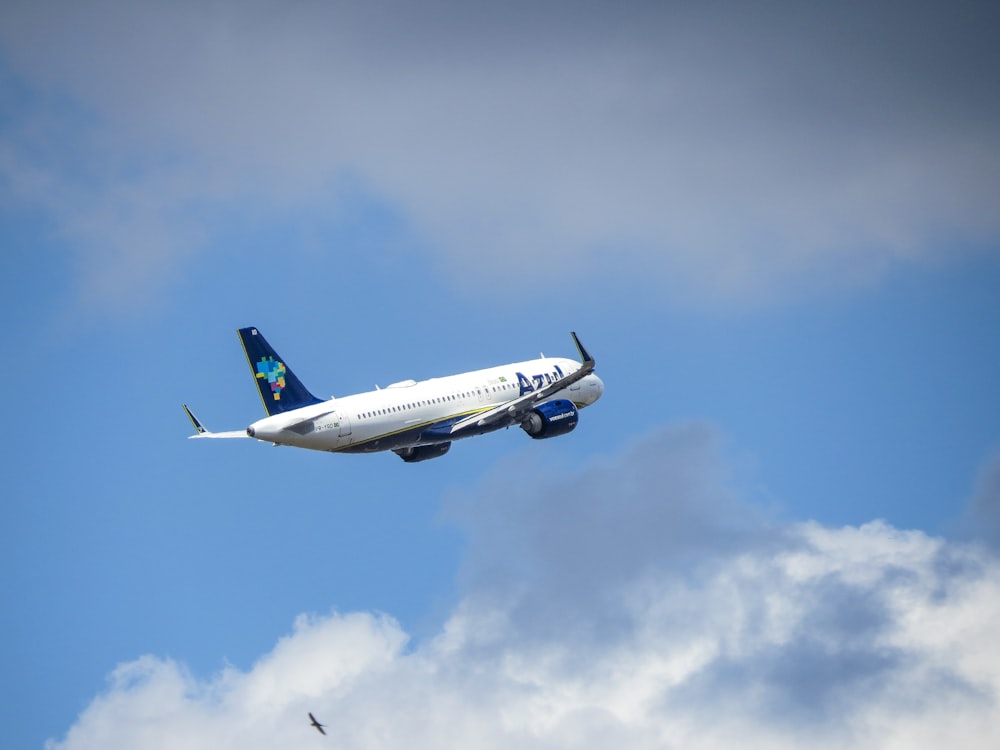 a large passenger jet flying through a cloudy blue sky