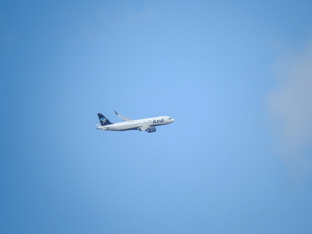 a large jetliner flying through a blue sky