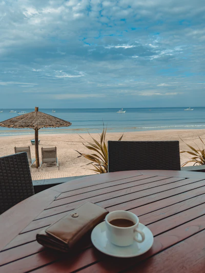 a cup of coffee sitting on top of a wooden table