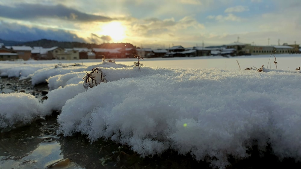 the sun shines through the clouds over the snow