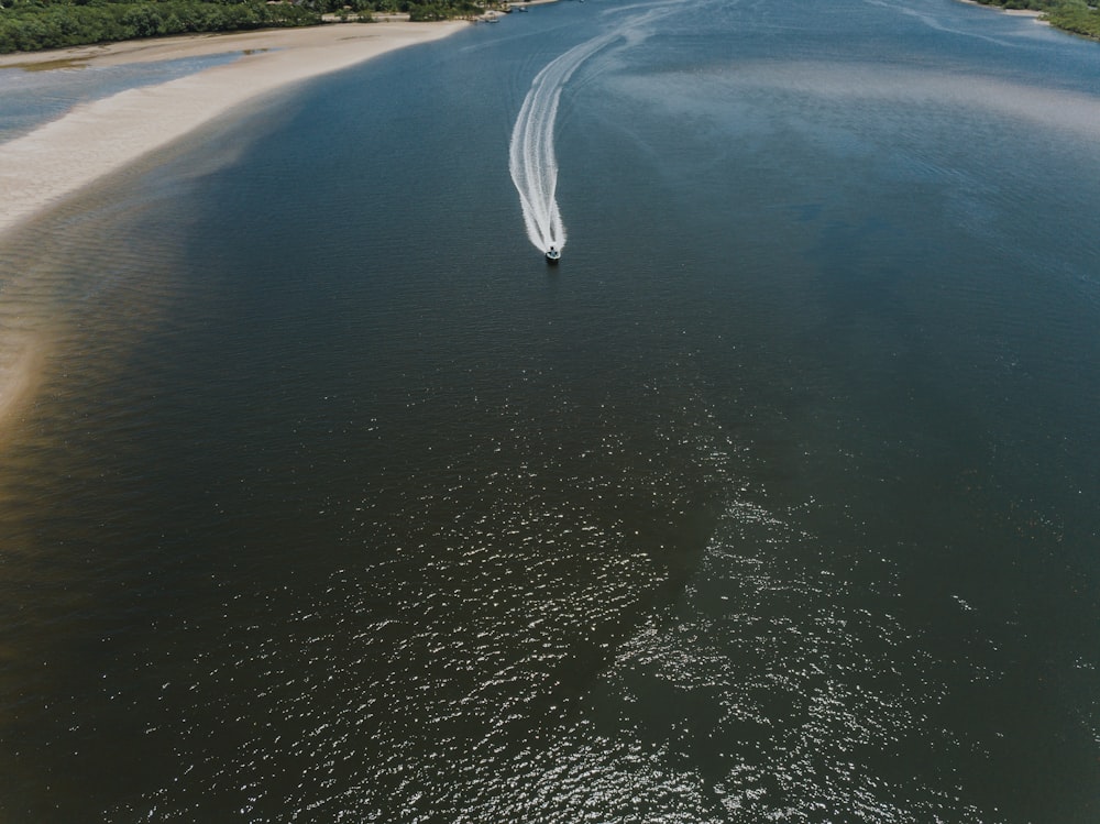 an aerial view of a boat on the water