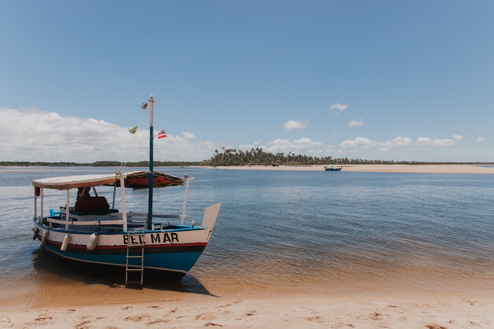 a boat sitting on top of a sandy beach