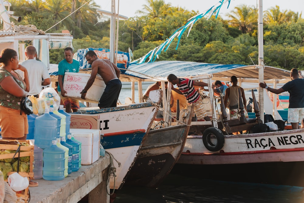 a group of people standing on top of a boat