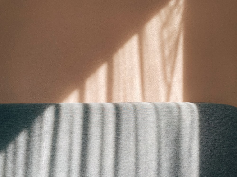 a bed with a white sheet and a window