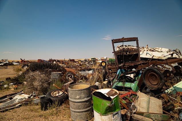 A bustling yard filled with various dismantled cars ready for part removal under clear Melbourne skies.