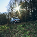 A freshly replaced windshield shining on a parked SUV under natural light.