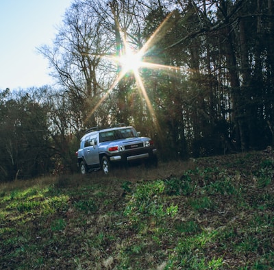 A freshly replaced windshield shining on a parked SUV under natural light.