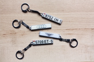 three keychains with the number five and the number five on them