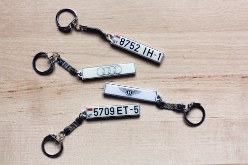three keychains with the number five and the number five on them