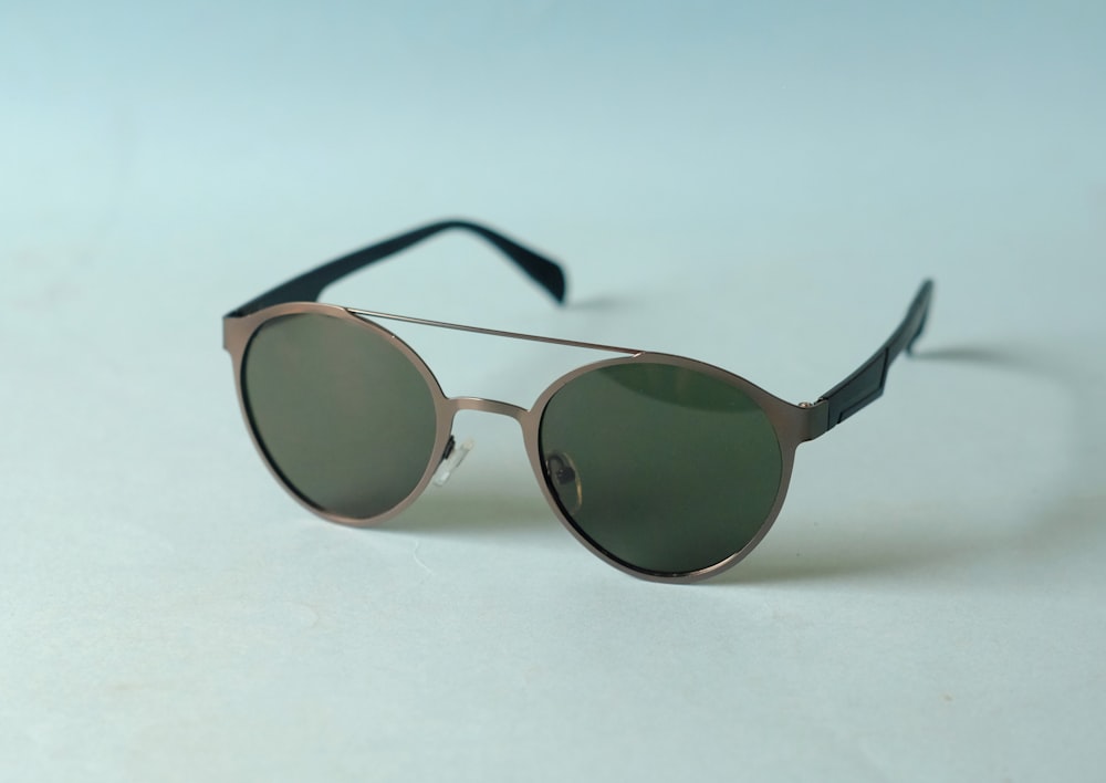 a pair of sunglasses sitting on top of a white table